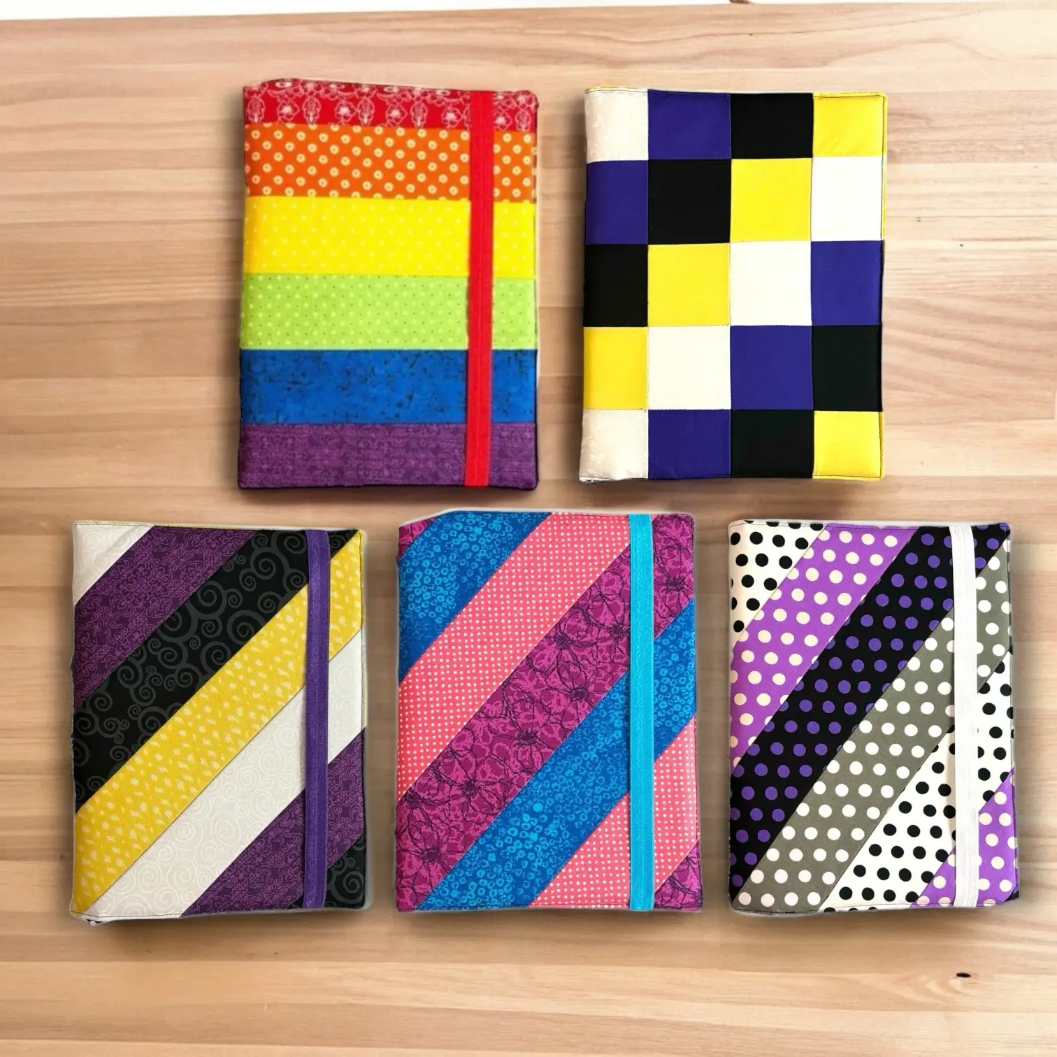 Celebrate Pride Month with D-Marie’s Sweet Threads' vibrant collection of fabric-covered composition notebooks inspired by Pride flags.