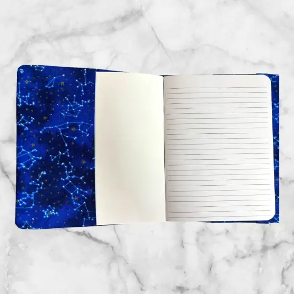 Mythical Blue Dragon notebook cover featuring a blue dragon soaring through a starry sky with a blue elastic band for closure.