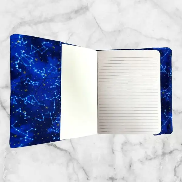 Mythical Blue Dragon notebook cover featuring a blue dragon against a starry sky with a moon and a blue elastic band for closure.