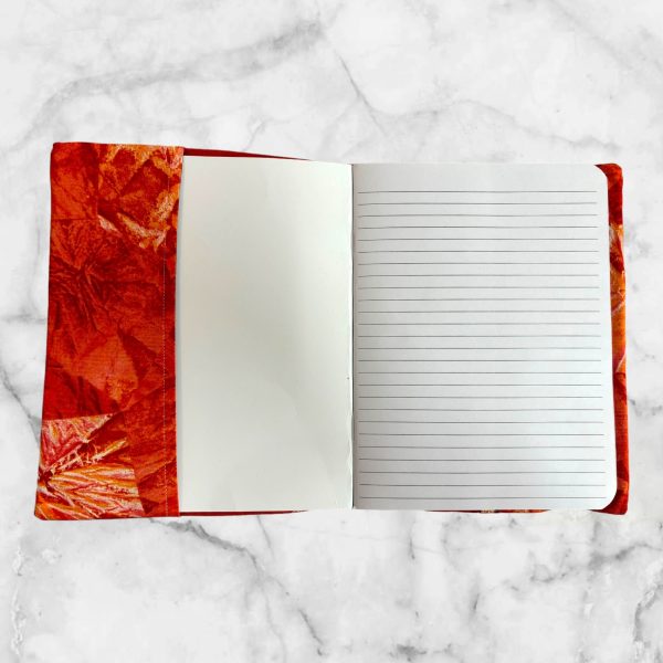 Dragon Fyre notebook cover featuring a red dragon emerging from flames on a red background with a gold elastic band.