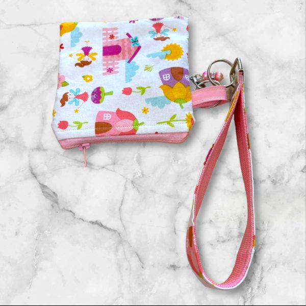 A pastel-colored Whimsical Fairy Tale Wristlet Key Fob and Card Wallet with fairy and castle scenes.