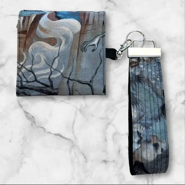 A Vintage Skulls Wristlet Key Fob and Card Wallet with detailed skulls in earthy, muted tones.