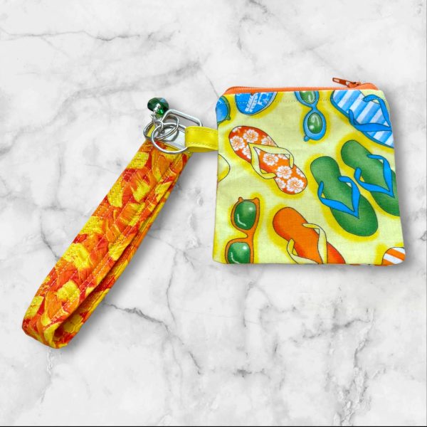 A Summer Vibes Wristlet Key Fob and Card Wallet with colorful flip-flops and sunglasses patterns.