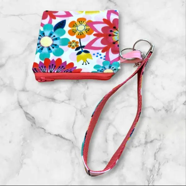 A Bright Blooms Wristlet Key Fob and Card Wallet with large, vibrant flowers in turquoise, yellow, and red.