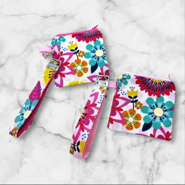 A Bright Blooms Wristlet Key Fob and Card Wallet with large, vibrant flowers in turquoise, yellow, and red.