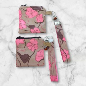 A Subtle Chic Wristlet Key Fob and Card Wallet with delicate pink flowers on a taupe background