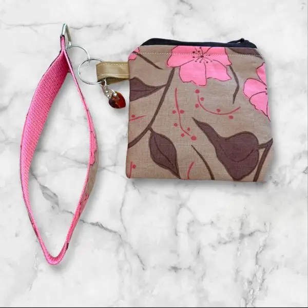 A Subtle Chic Wristlet Key Fob and Card Wallet with delicate pink flowers on a taupe background