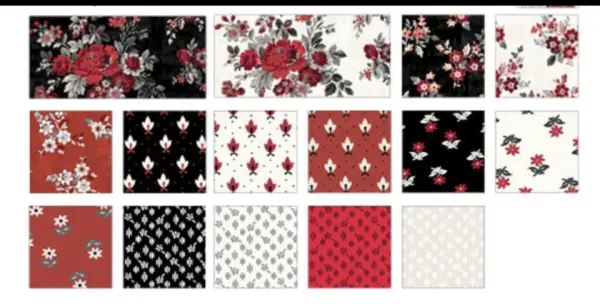 A reversible Ruby Splendor Quilt featuring rich red, black, and white floral patterns on one side and a complementary design on the other, measuring 53” x 70”.