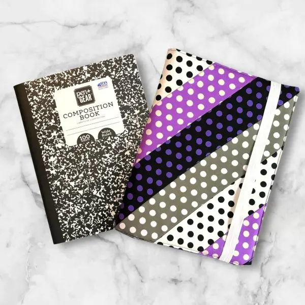 Polka Dot Striped composition notebook cover featuring stripes of black, grey, white, and purple polka dots with a white elastic band.