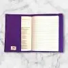 Polka Dot Striped composition notebook cover featuring stripes of black, grey, white, and purple polka dots with a white elastic band.