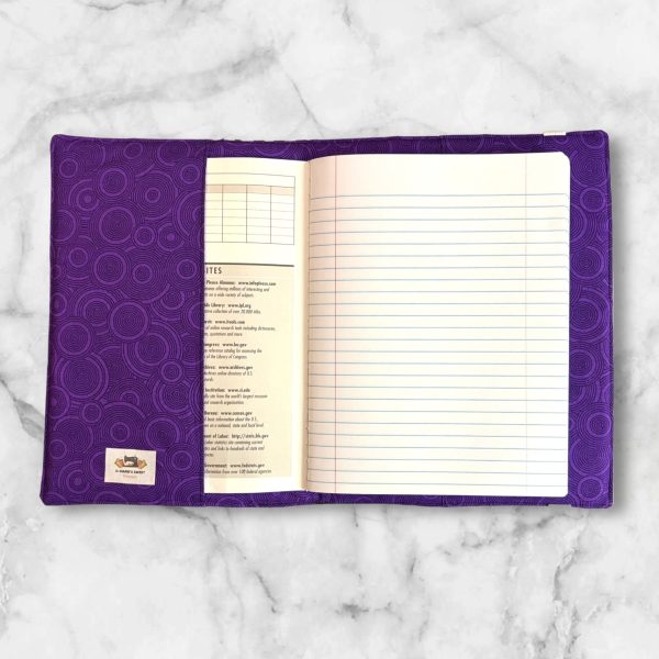 Polka Dot Striped composition notebook cover featuring stripes of black, grey, white, and purple polka dots with a white elastic band.