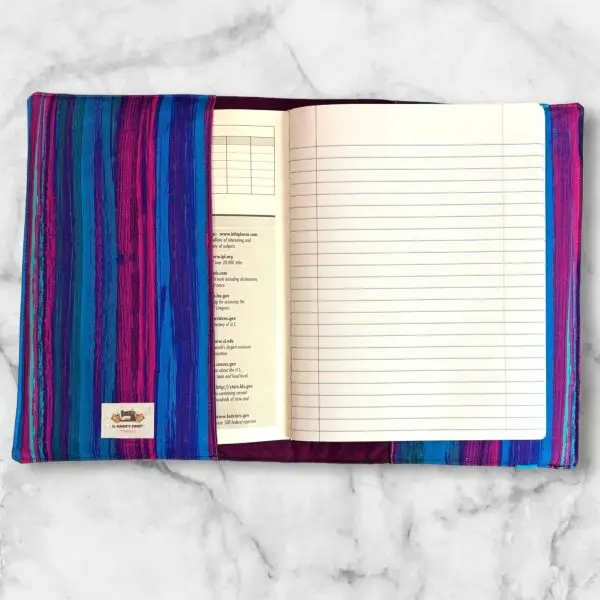 Pink, Purple and Blue Diagonal composition notebook cover with vibrant stripes and a blue elastic band.