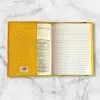Checkerboard pattern composition notebook cover featuring yellow, white, purple, and black squares with a matching elastic band.