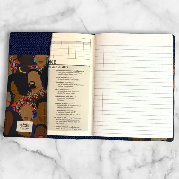 African American Print composition notebook cover featuring powerful Black faces design with a blue elastic band.