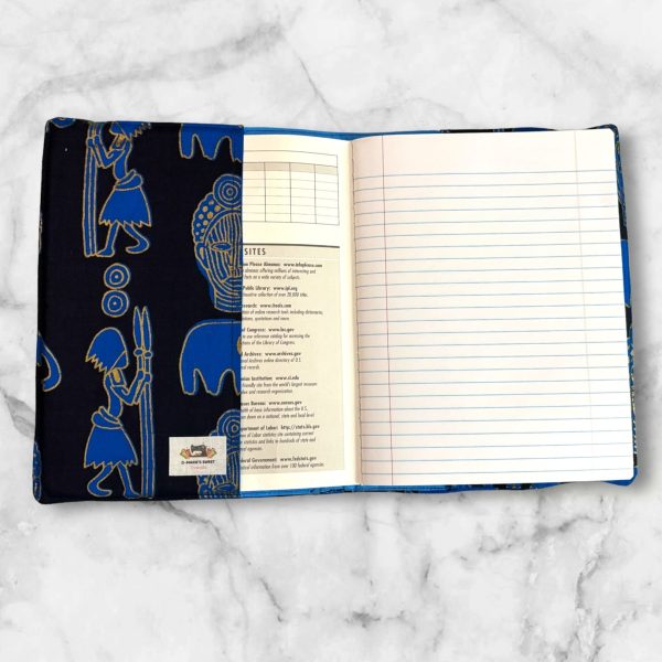 Blue African Symbols composition notebook cover featuring blue symbols with gold accents on a navy blue background with a gold elastic band.