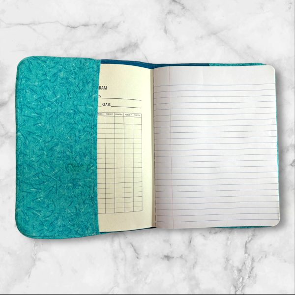 Dragon Fyre composition notebook cover with a majestic dragon on a turquoise background, featuring a brown textured spine.