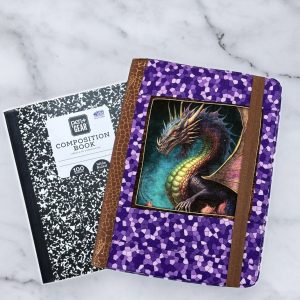 Dragon Fyre composition notebook cover with a detailed dragon on a deep background, accented with purple geometric fabric and brown spine.