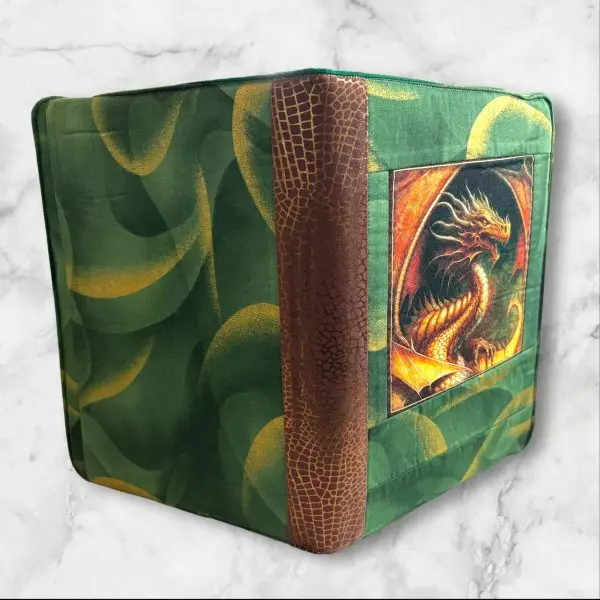 Dan Morris Dragon Fyre composition notebook cover featuring a golden dragon on a forest-green background with brown accents.