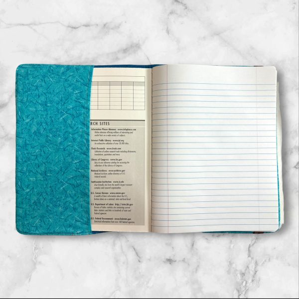 Dragon Fyre composition notebook cover with a majestic dragon on a turquoise background, featuring a brown textured spine.