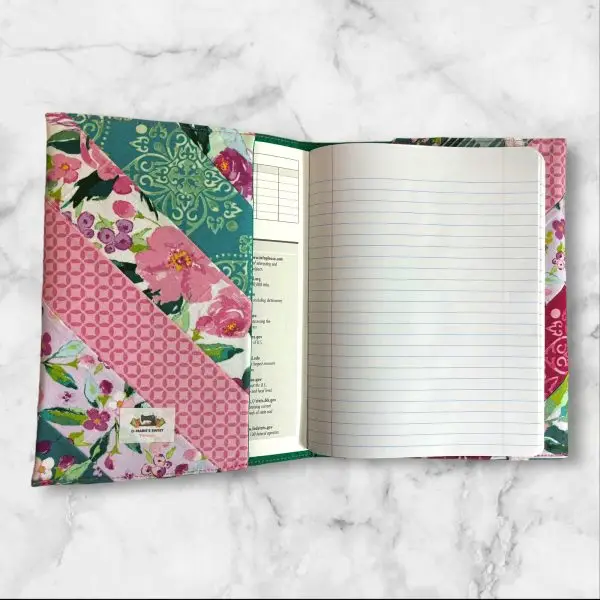 Quilted composition notebook cover with a mix of pink, green, and floral striped patterns, creating a fresh and elegant look.