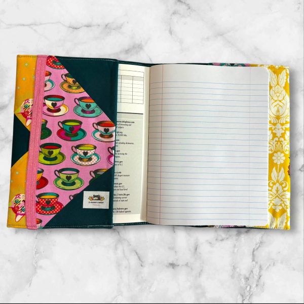 Quilted composition notebook cover with a vibrant, colorful design featuring a Queen of Hearts-inspired illustration in bold, artistic patterns.