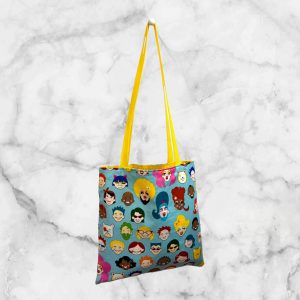 A colorful tote bag featuring a variety of cartoon faces representing diversity, designed by Alexander Henry, celebrating the LGBTQ+ community.