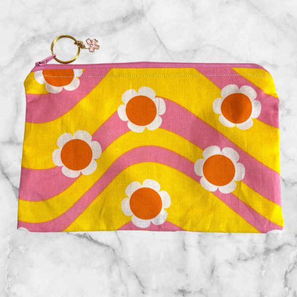 Retro Floral Waves Zipper Pouch with pink and yellow wave patterns and white flowers, featuring a pink zipper with a flower charm.